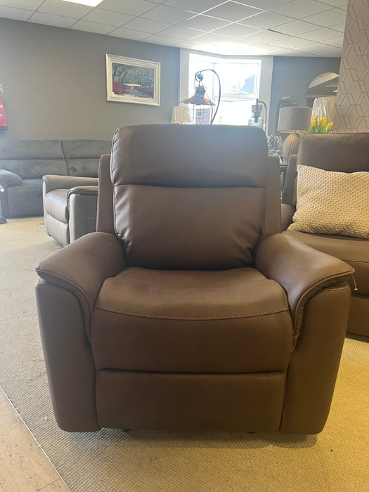 A plush brown motorised reclining chair with padded armrests, cushioned backrest, and extended footrest in a reclined position.