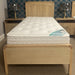 Wooden bed with a mattress in a bedroom setting