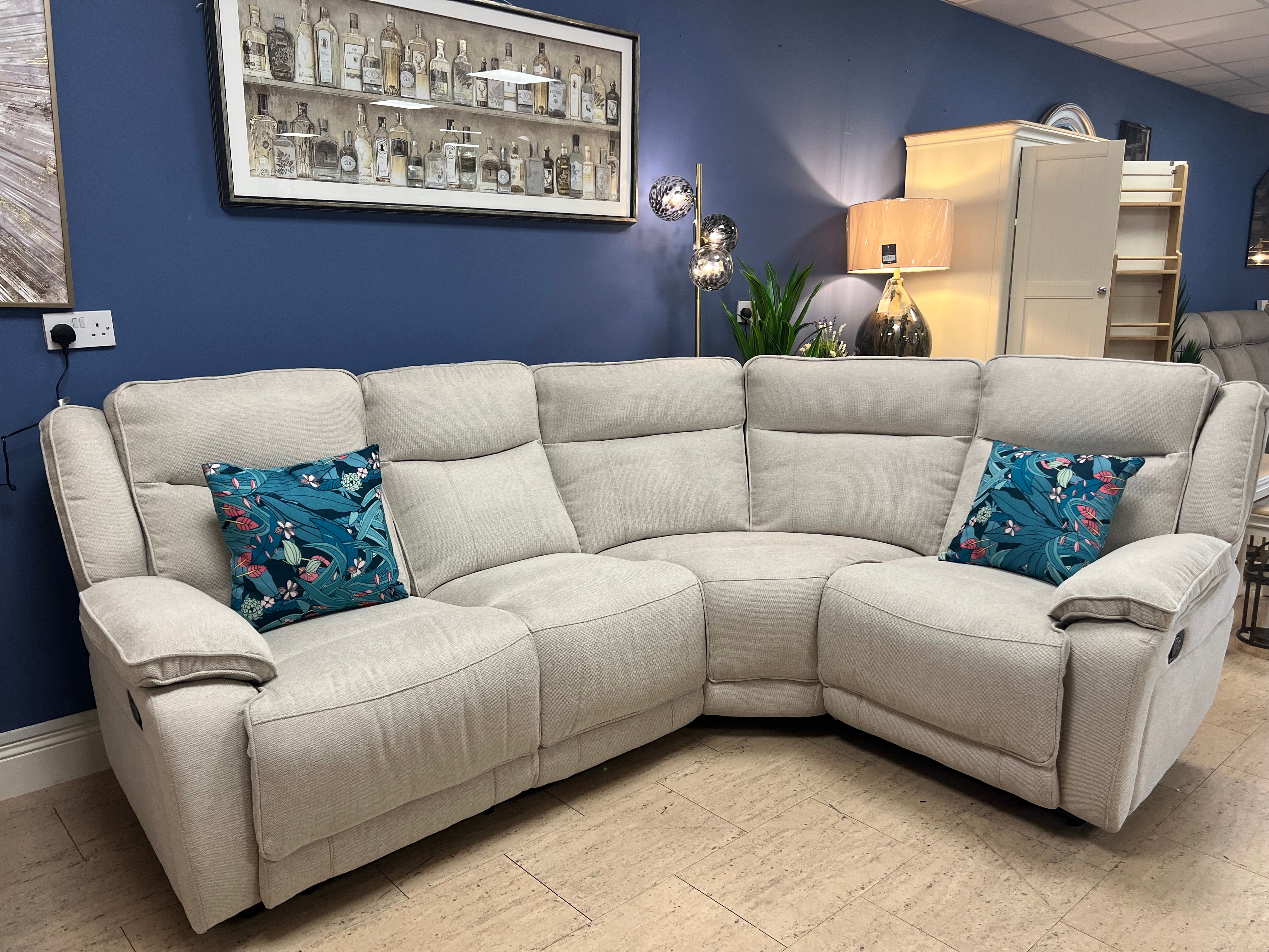 A modern biscuit coloured sectional sofa with two recliners, showcasing a stylish and comfortable design for any living space.